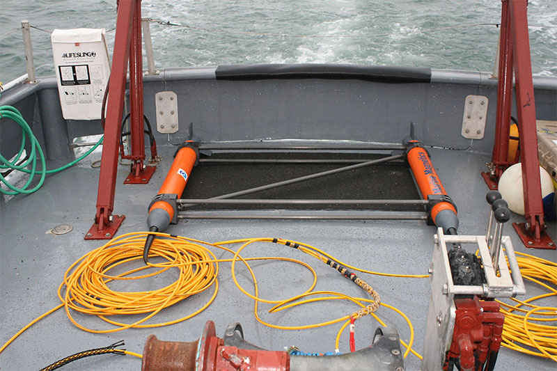 The gradiometer is comprised of two magnetometers separated from each other in a rigid framework, and in this picture, it is about to be deployed. Archaeologists soon discovered one of the instruments did not work.