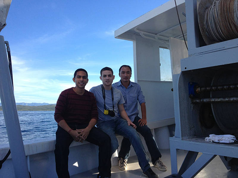 Danilo Rojas, Jesus Torrado, and Haibo Xu take a break while working onboard.