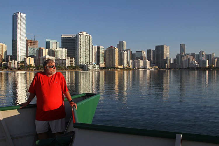 Chief Scientist Dennis Hanisak takes in the scenery as the University of Miami research vessel F.G. Walton Smith makes its its way through Biscayne Bay past downtown Miami