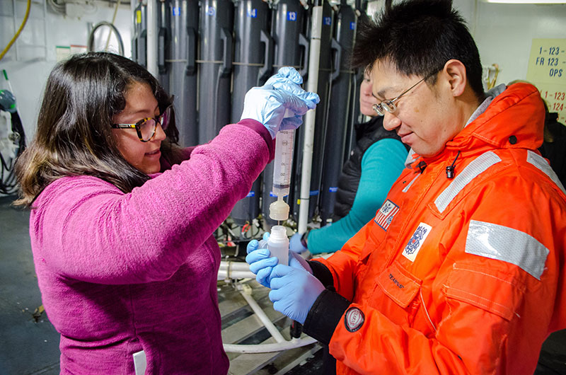 Heidi Mendoza-Islas and Atsushi Yamaguchi, from Hokkaido University, filter seawater collected from the CTD.