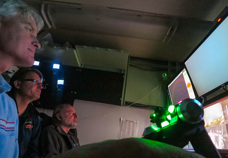 Dr. Dhugal Lindsay (middle) and Dr. Russ Hopcroft (right) identify water column species while Joe Caba (left) pilots the ROV Global Explorer.