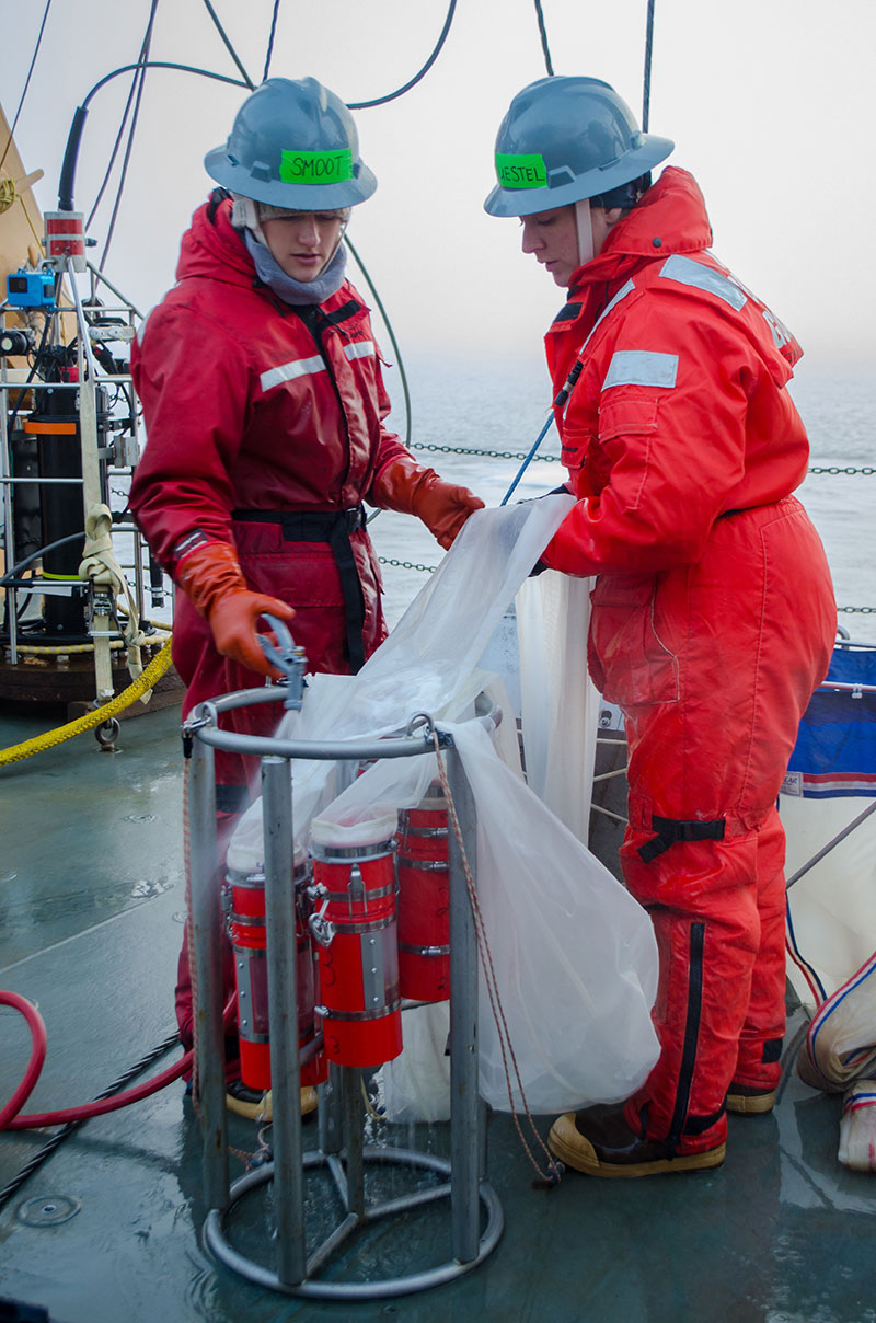Caitlin Smoot and Dr. Jennifer Questel hose down the plankton net after a successful deployment and recovery.