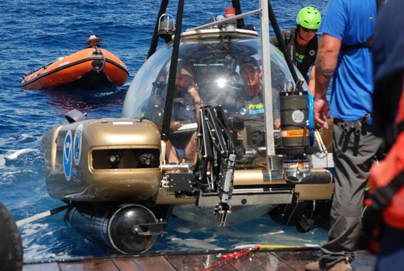 The manned submersible NEMO containing a pilot and an archeologist is being lowered into the ocean for its first dive.