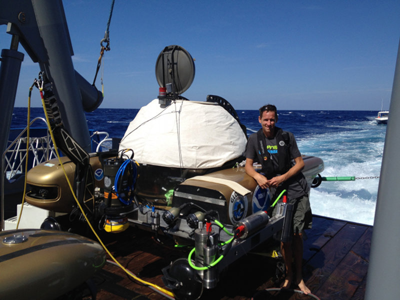 Pilot Randy Holt standing next to the Triton submersible.