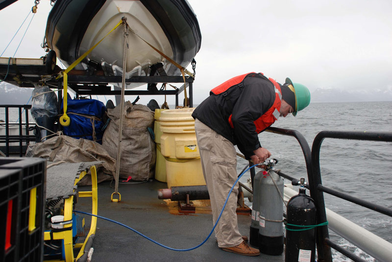 While working in remote areas like Glacier Bay National Park, we need to bring our own compressor. Here Jeff Godfrey fills tanks between dives.