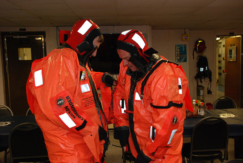 U.S. Geological Survey scientists Jason Chaytor and Brian Andrews in the process of fully securing their immersion suits.
