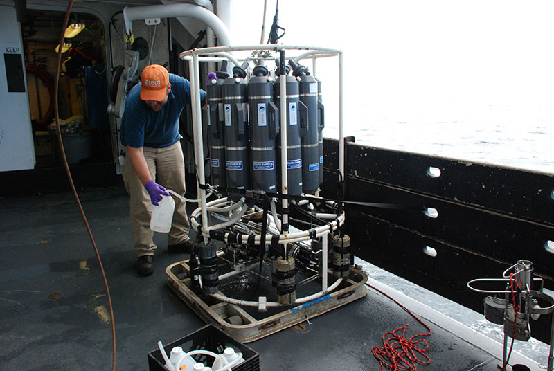 After the CTD has been recovered, Jason Chaytor attaches a tube to each Niskin bottle and transfers the water into plastic jugs, which will be brought into the lab and filtered.