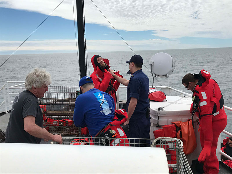 Donning immersion suits during drills.