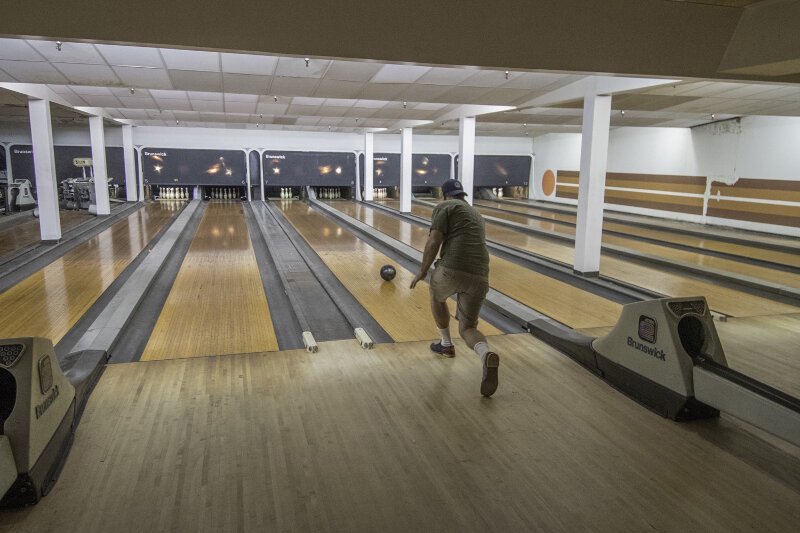The team tries their hand at bowling after a long day on the water.