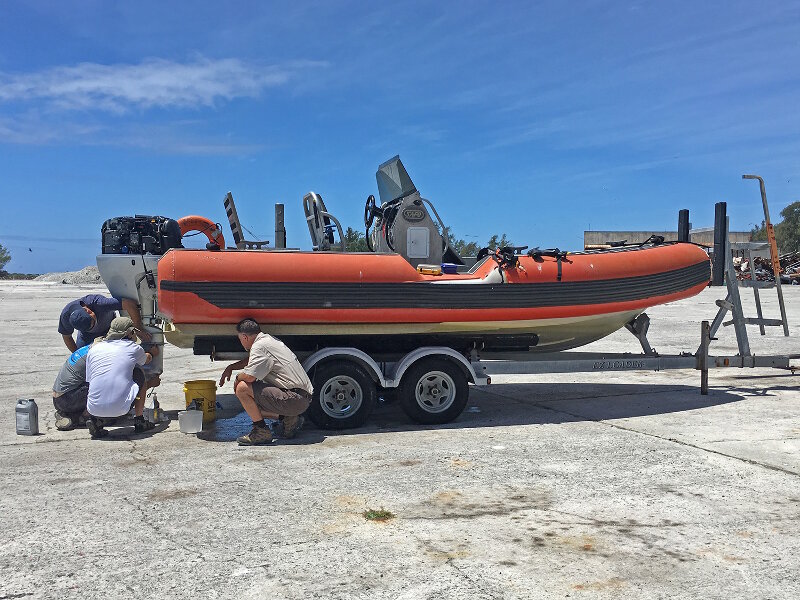 The team readies one of the U.S. Fish and Wildlife Service small boats for operations at Midway Atoll.
