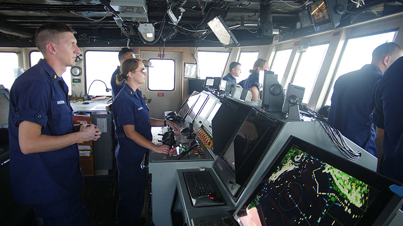 Left to right: ENS Lee Shoemaker, ENS Sara Thompson, ENS Brandon Tao, Capt. Donn Pratt, ENS Hillary Fort, ENS Keith Hanson, and LCDR Tony Perry III on the bridge of NOAA Ship Nancy Foster, transiting from port out to sea.
