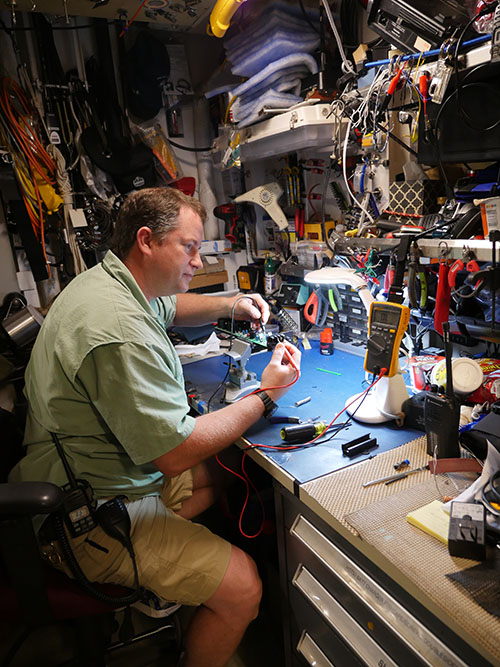 Chief ET Keith Martin repairing a circuit board in the ship’s ET shop.