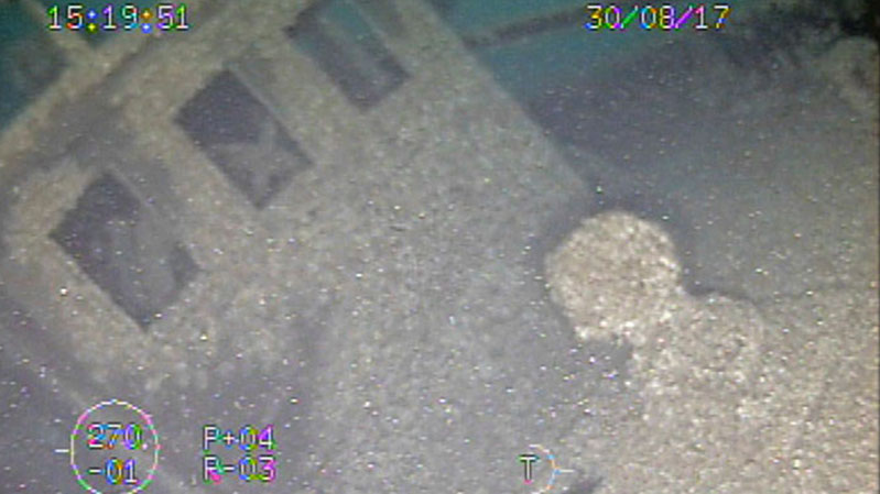 While hovering over the bow of the Ohio, the ROV imaged both the capstan and pilot house. Just inside the left windows of the pilot house, the ship’s wheel is visible.