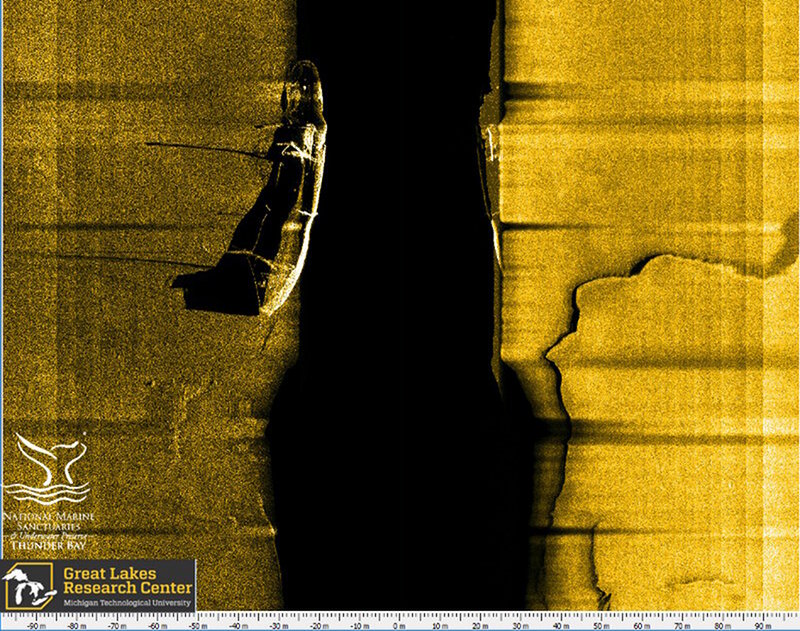 Here, an AUV sonar scan runs parallel with the long axis of the vessel researchers believe is that of wooden bulk carrier Ohio. Two upright masts are easily seen fore and aft, while a third collapsed mast can be seen via its shadow amidships. Likewise, the acoustic shadow of the pilot house forward reveals a textbook bulk carrier design feature.