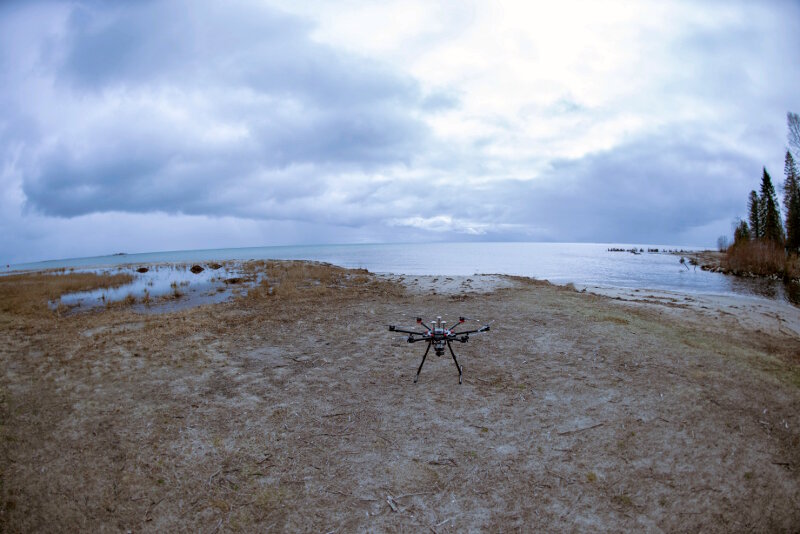 Trumball Unmanned DJI Matrice 600 Pro sits ready for a survey mission next to the back of Black River.