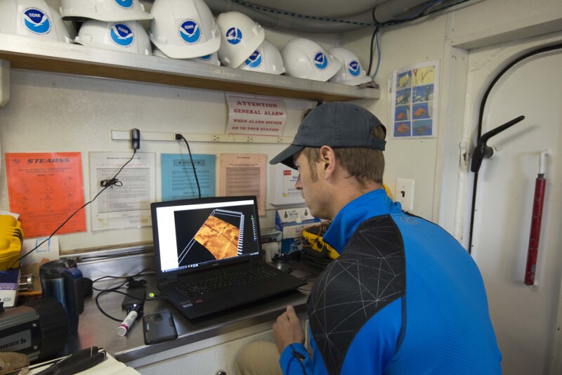University of Delaware sonar technician Kenny Haulsee reviews sonar files as part of a data processing workflow.