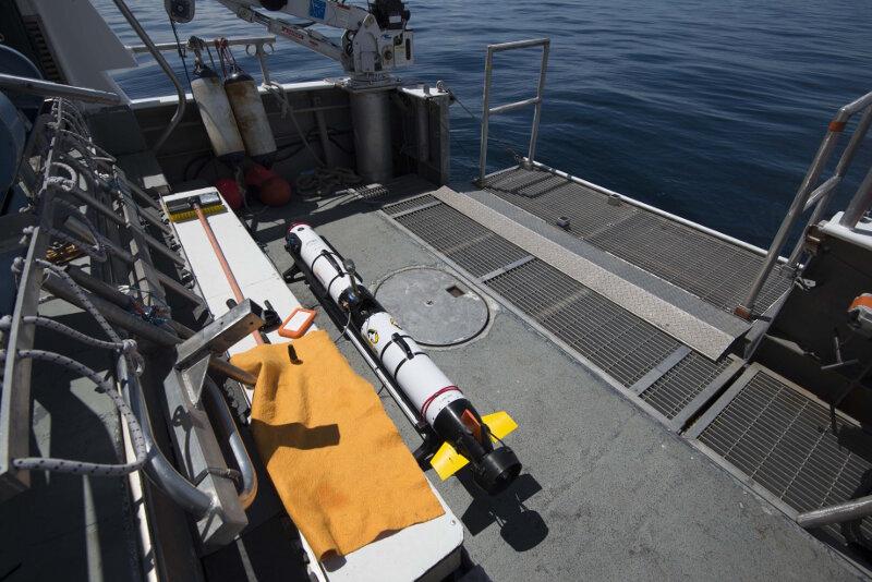 MTU’s Iver3 AUV on the back deck of R/V Storm following survey mission. The vehicle was launched and recovered from the vessel’s retractable tailgate, and is shown transferring data to a portable drive for immediate review by researchers. The ability to review the sonar data in real time was extremely useful for making adjustments to mission planning parameters used in subsequent survey runs.