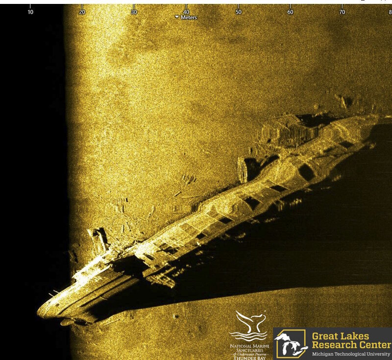 Bulk freighter Norman was a large steel vessel, the predecessor to the modern-day Great Lakes Bulk Carrier. In May of 1895, Norman collided with Canadian steamer Jack off Presque Isle; Norman’s hull was broken forward of the boiler house, causing it to sink in nearly 200 feet of water. This sonar image passes closely over the freighter’s stern, showing the side of the aft cabin, the break in the hull, cargo hatches moving forward, terminating at the vessel’s bow.
