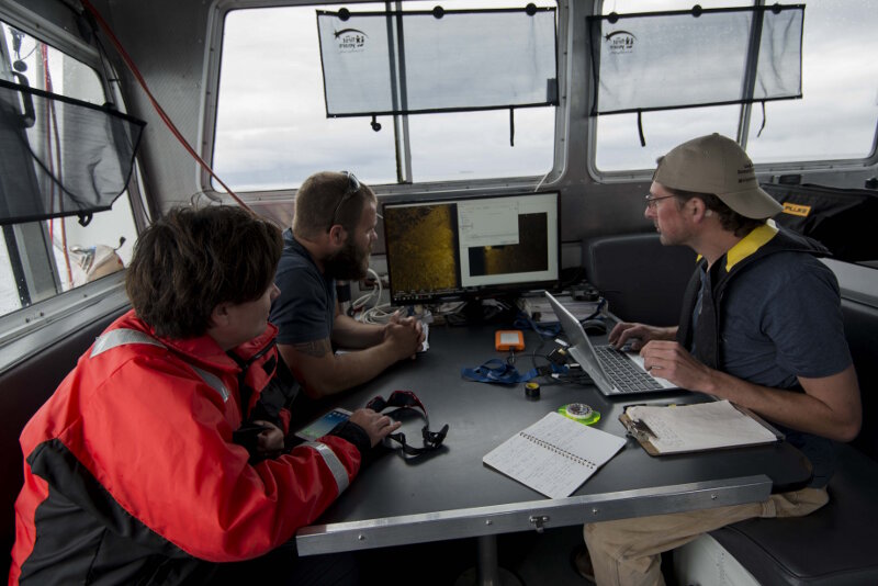 Maritime Archaeologists John Bright and Stephanie Gandulla review sonar data with MTU’s Chris Pinnow following an AUV mission over bulk carrier Norman.