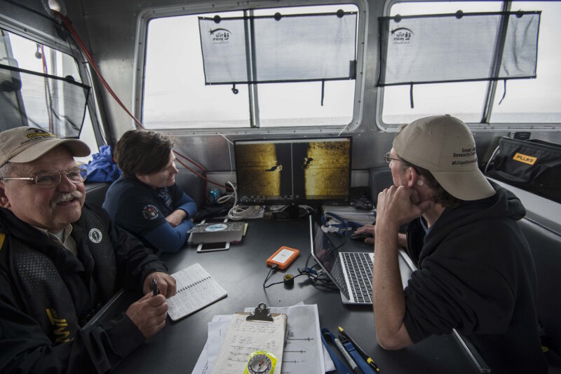  Dr. Guy Meadows and Chris Pinnow review AUV sonar data with Thunder Bay National Marine Sanctuary archaeologist Stephanie Gandulla onboard R/V Storm.