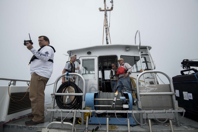 Jamey Anderson (left), Marine Operations Coordinator at the Great Lakes Research Center, sends wireless commands to the vehicle at the start of a survey mission. Technician Chris Pinnow, Dr. Guy Meadows, and Michael Beaulac look on, ready to begin the topside mission tracking. Each run lasted between 30-90 minutes.