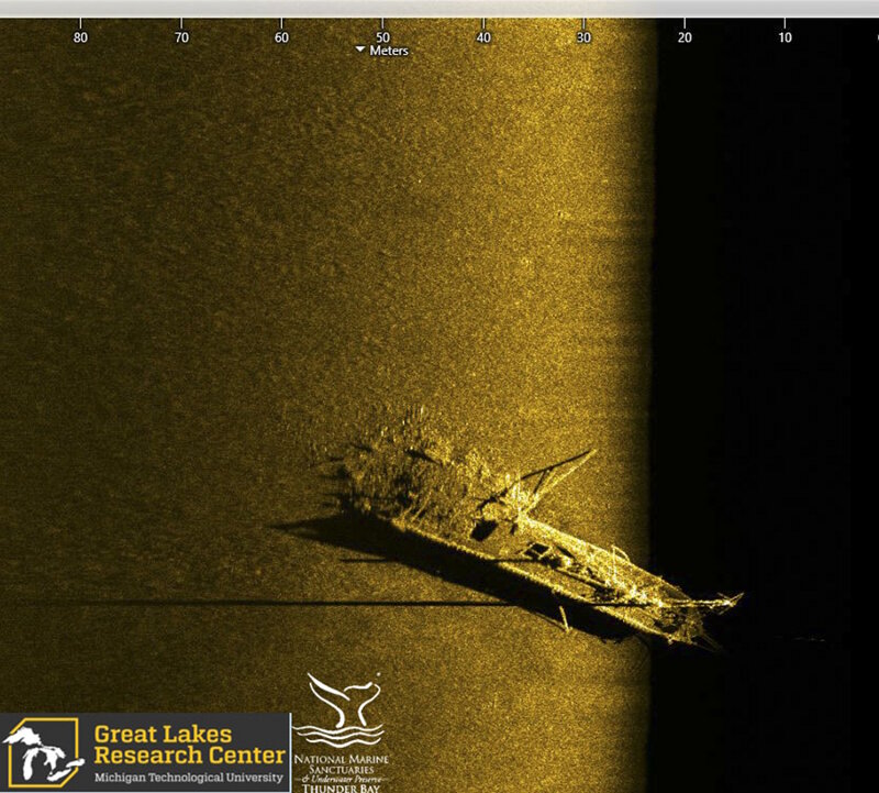 Side scan sonar image of schooner Typo, which collided with steamer W.P. Ketcham in October of 1899. The schooner, which was carrying a cargo of coal, was rammed in the stern. The sonar image show the bow and upright foremast, cargo hatches across Typo’s deck, and the broken stern with a pile of spilled coal.