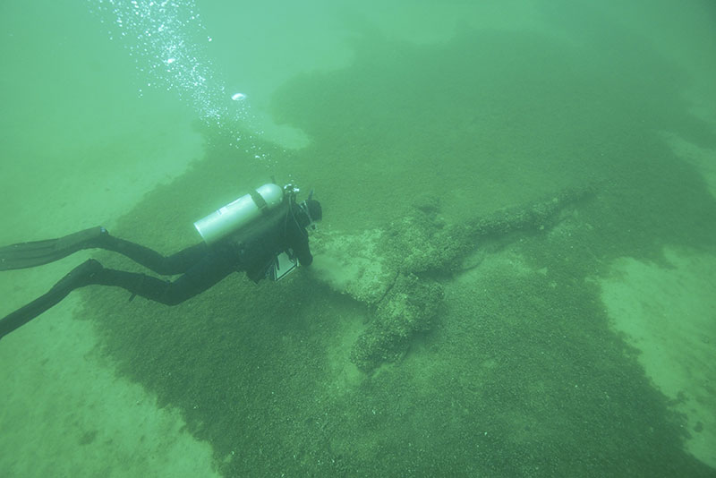 State Maritime Archaeologist Wayne Lusardi investigates the only aircraft found during the survey, a military tow target from the 1950s (Photo by John Bright).