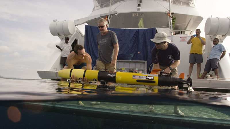 Andy Nager, Mark Moline, and Eric Gallimore deploy an UUV in the field.