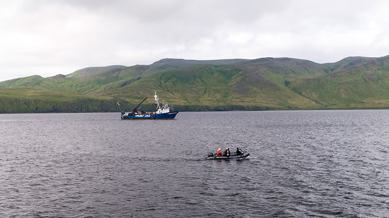 The dive team deploying to investigate sonar targets collected via the REMUS 100 AUV, with the R/V Norseman II sailing in the background.
