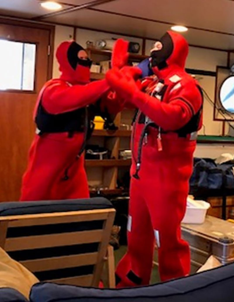 Putting on our survival suits on the first day of safety drills. You can see why they are called “Gumby” suits!