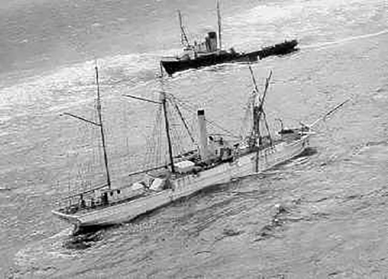 Last known image of the famous cutter Bear not long before she took the final plunge to the bottom. Notice damaged rigging, high seas and sea-going tug Irving Birch in the background. 
