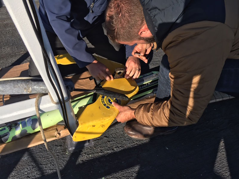 John Bright and Joe Hoyt installing the new tow-point bracket on the side scan “fish.”