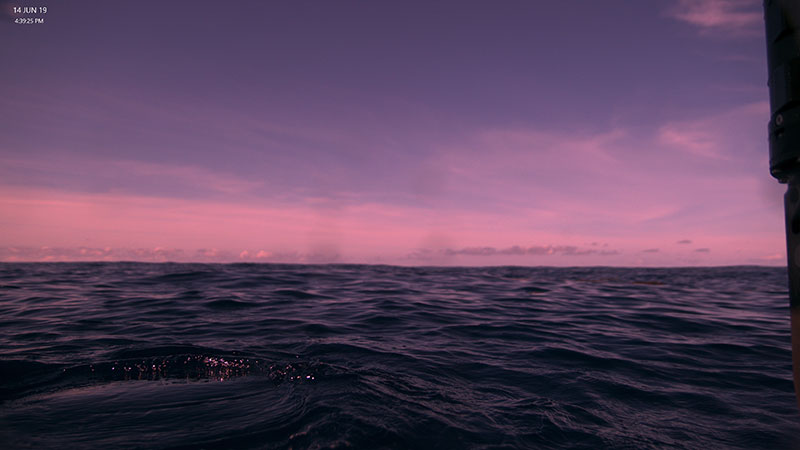 View at the ocean surface from the Global Explorer ROV during its recovery to R/V Point Sur at the end of a dive. The color in the image is altered from the filters set for deep water.