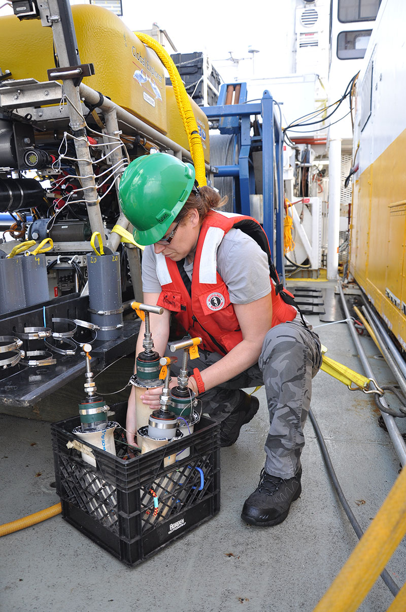 Jennie McClain offloading sediment cores from the remotely operated vehicle after a dive at Alderdice bank. Sediments are processes and preserved for isotope analyses back in the laboratory.