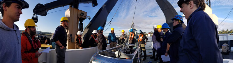 Crew officers and scientists on the Reuben Lasker being training on the operation of the ROV and AUV.