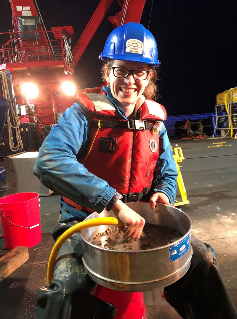 Brittany Jones is carefully rinsing the top layer of the mud over a fine mesh to look for tiny critters inhabiting the deep sea. 