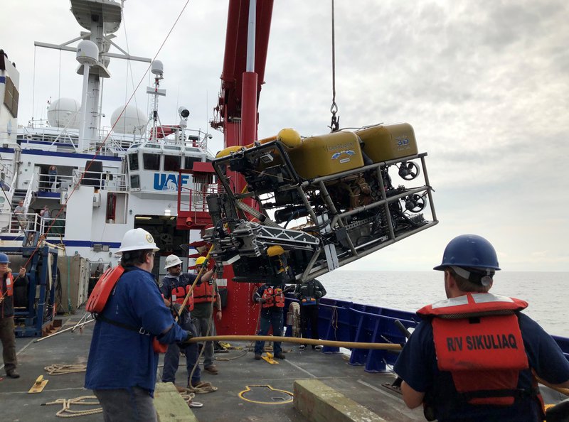 The Global Explorer ROV is being lifted over the side of the ship for a dive.