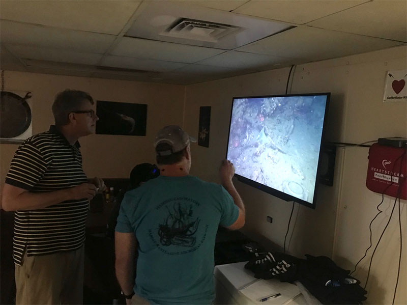 BOEM Archeologist Doug Jones discussing with NRL Geophysicist Dr. Warren Wood various images seen at our shipwreck site of the day.
