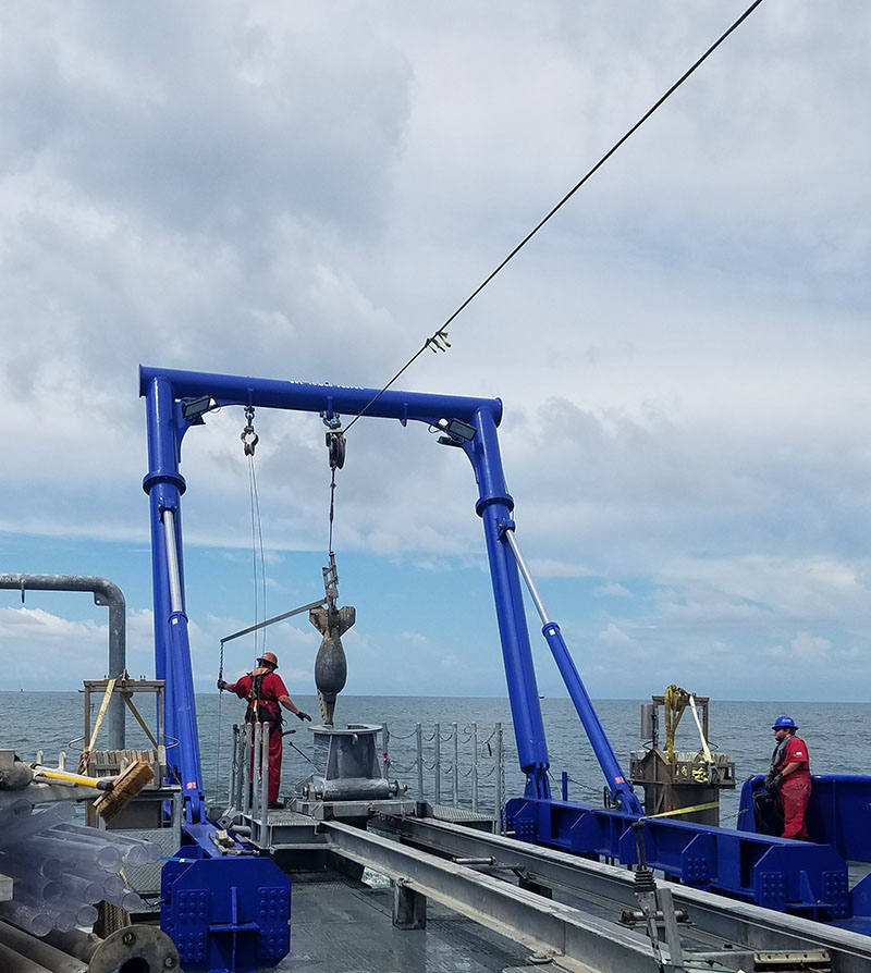 The piston coring rig deployed over the stern, and just prior to sampling.