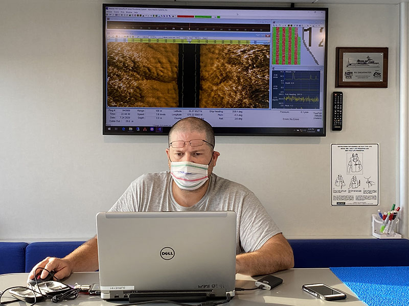 Dr. Nathan Richards, director of East Carolina University’s Program in Maritime Studies, processing data collected using the side scan sonar.