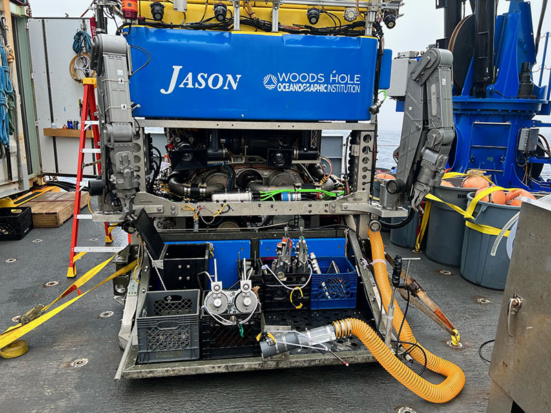 The front of remotely operated vehicle Jason. There are two arms with manipulator claws, one on the left and one on the right. Samples collected during dives are stored on the platform between the arms.