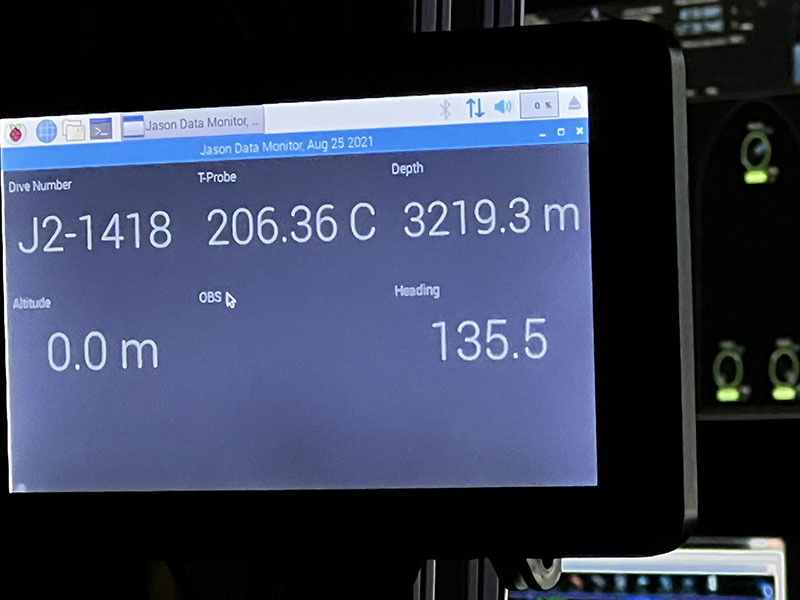 During an Escanaba Trough: Exploring the Seafloor and Oceanic Footprints expedition dive, the team gathered a sample of boiling water (206 degrees Celsius/403 degrees Fahrenheit!) from a hydrothermal vent located at a depth of 3,219 meters, almost two miles below the surface. This image shows the monitor displaying the depth and temperature of the probe. Note that the temperature away from the hot water plume is between one and two degrees Celsius (about 35 degrees Fahrenheit).