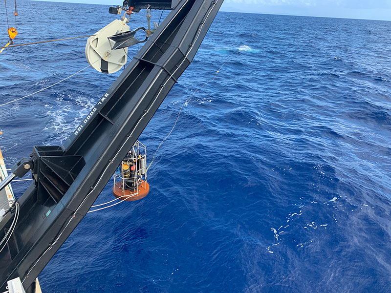 This image shows the winch deploying the clump weight which is used as a tether between remotely operated vehicle (ROV) Global Explorer and the ship. This weight takes the pitch and roll of the ship, allowing the ROV to explore without being impacted by the movements of the ship.