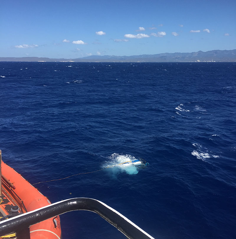 Recovery of remotely operated vehicle Global Explorer following an Illuminating Biodiversity in Deep Waters of Puerto Rico 2022 expedition dive at Guayanilla Canyon with the south coast of Puerto Rico in the distance.