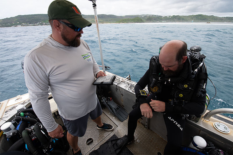 Joe Hoyt with the NOAA Diving Program prepares to enter the water in his rebreather.