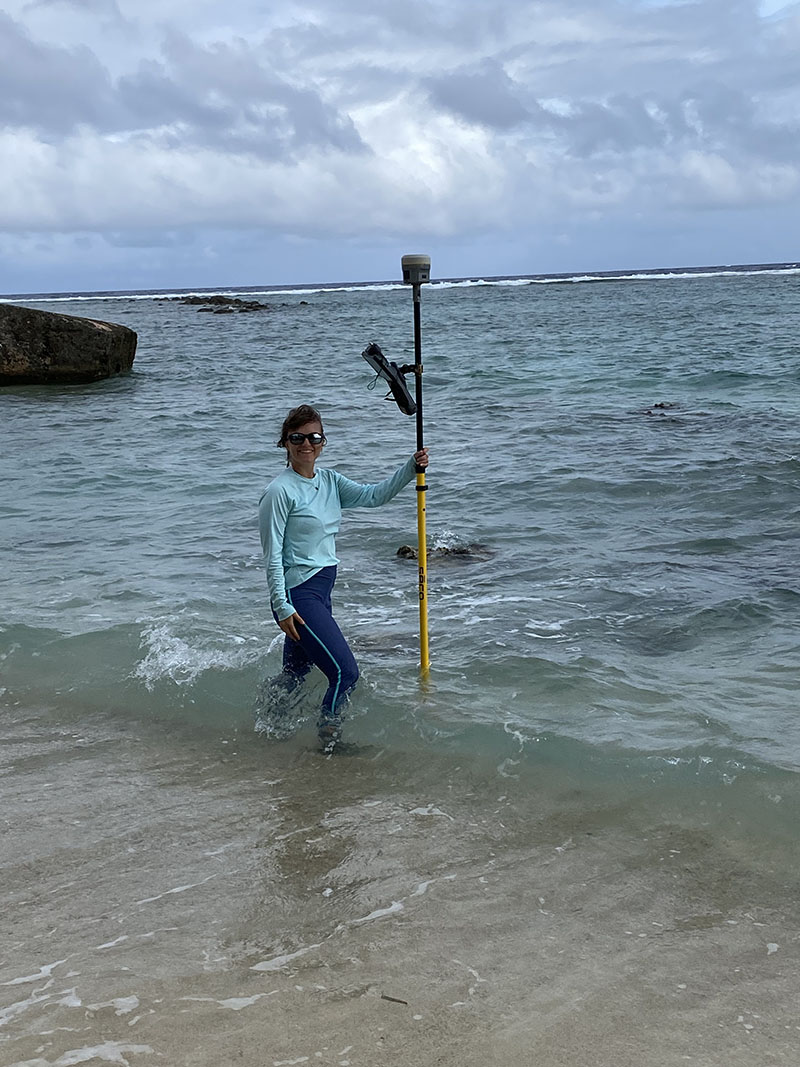 Oliva Helinski, from the National Park Service’s Volunteers-in-Parks Program, preparing to collect elevation data of a partially submerged boulder wall in the nearshore waters of the Asan unit of War in the Pacific National Historical Park..