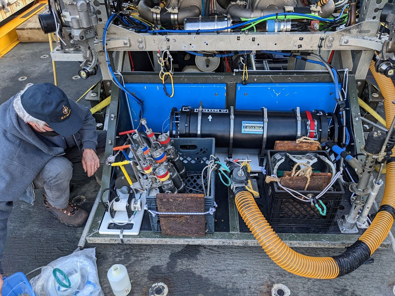 Dave Butterfield checks fluid connections to the recently developed methane sensor (large black pressure case) on remotely operated vehicle Jason’s tool sled during a field test in 2022.