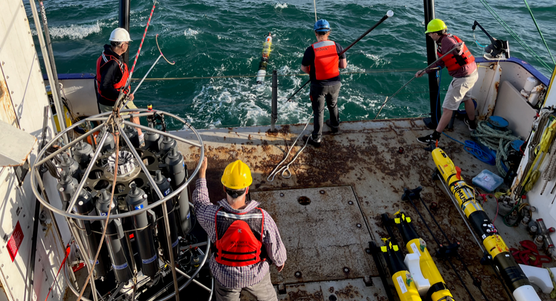 The project team deploying an autonomous underwater vehicle from the deck of Research Vessel <i>Rachel Carson</i>.