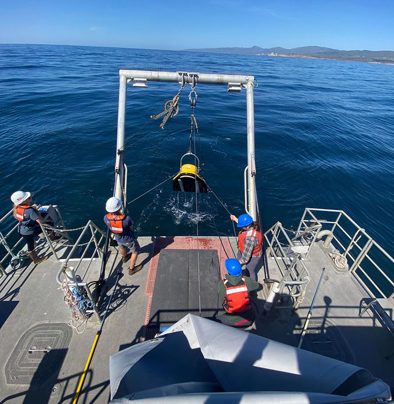 Amy Gusick and Shannon Klotsko retrieve the sub-bottom towfish, with help from Channel Islands National Marine Sanctuary Research Vessel Shearwater crew, Zacary Montgomery, Jackie Buhl, and Matt Howard (not pictured).