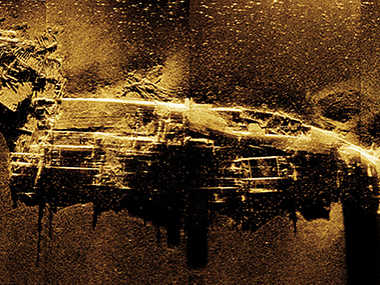 Sonar image of the Kotohira Maru shipwreck in gold tones against a dark background.